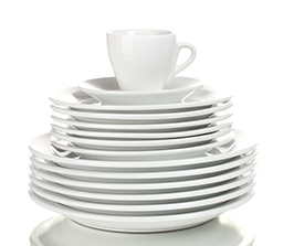stacked clean plates with a cup on top